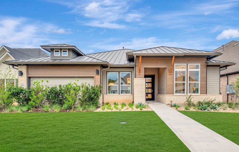 Exterior image of model home at kissing tree