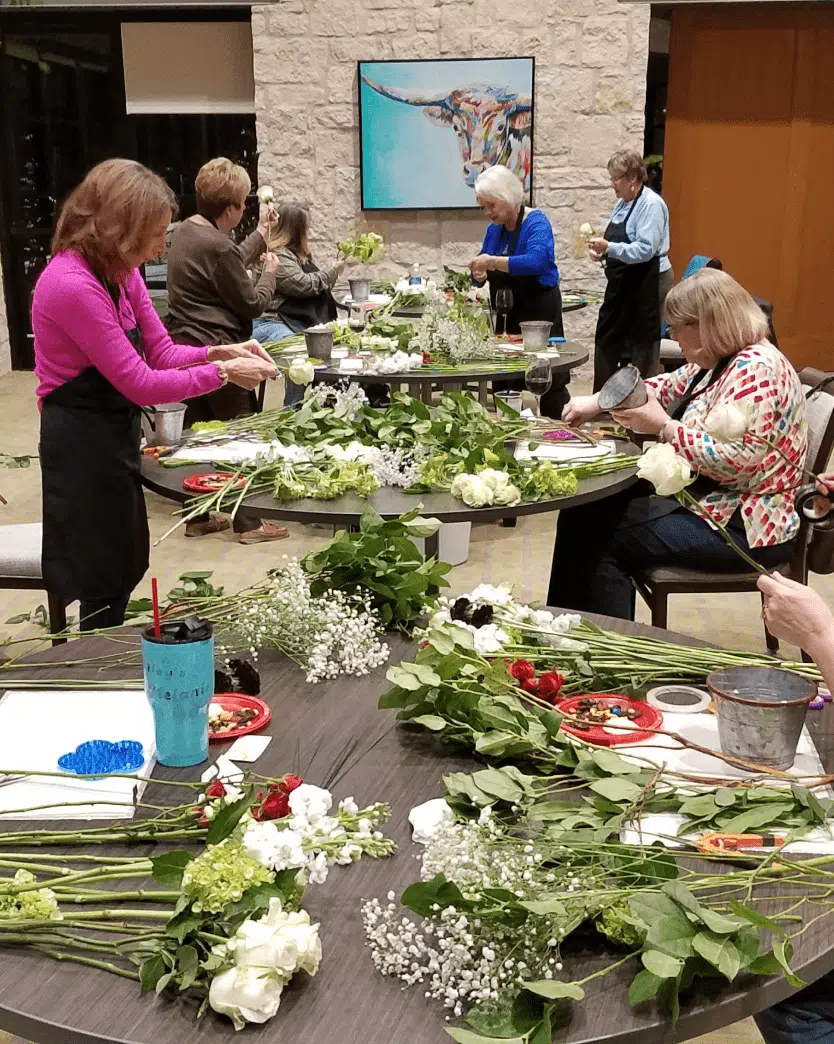 Women working together on flower decoration of KT