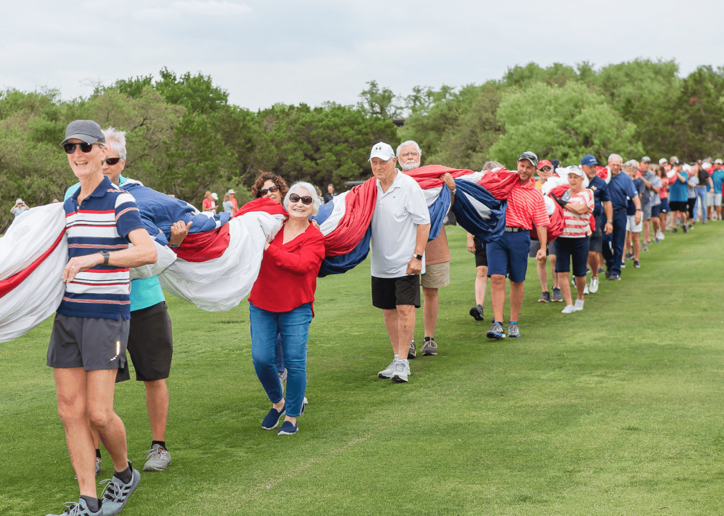 Residents Carrying Large US Flag Together