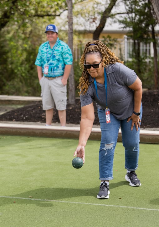 person playing bocce ball at kissing tree