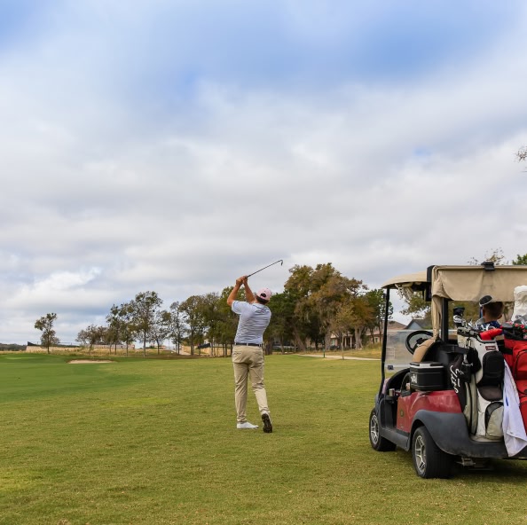 people playing golf at kissing tree