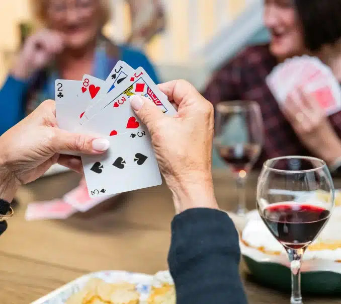 person playing cards at kissing tree