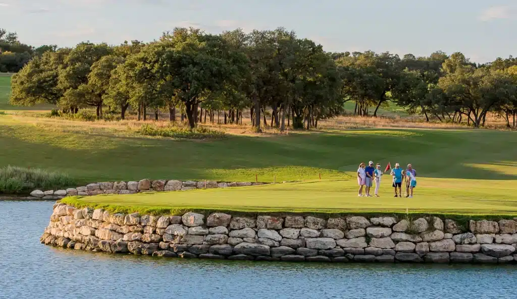 The 18-hole golf course at Kissing Tree — limestone, water, and Hill Country oak canopy