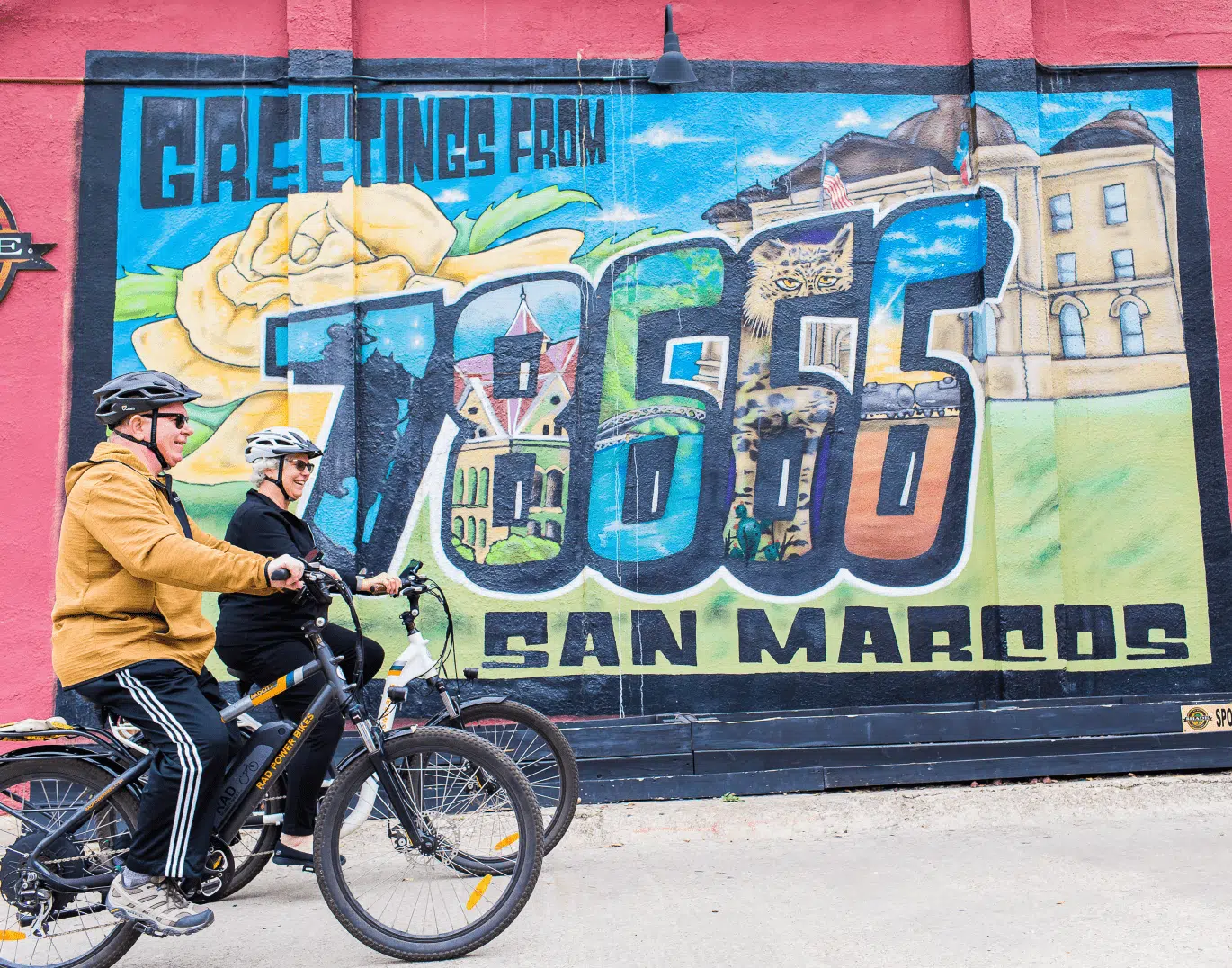 Area Guide 78666 in San Marcos - Mural on the wall and couple driving bicycles